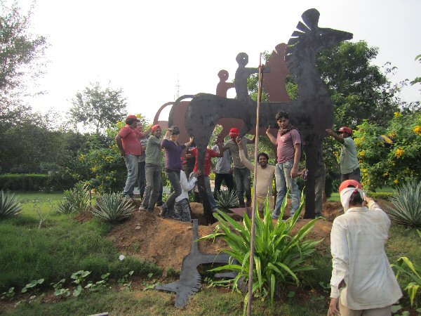 Zhang Yaxi and assistants during the installation phase of "Horses & Riders"