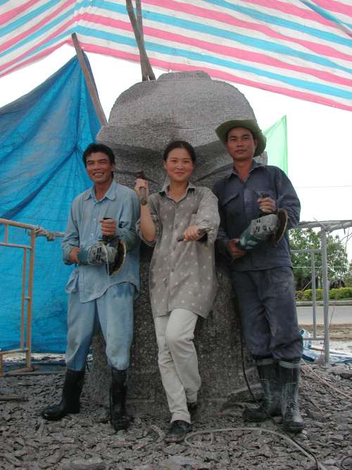 Two stone workers and Zhang Yaxi in front of the General Ba sculpture - December 2003, Vietnam