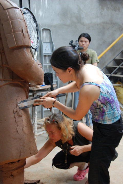 Chinese sculptor Zhang Yaxi working on the Roger Federer tennis terracotta warrior sculpture in Chonqging for the Tennis Master Cup Shanghai 2007 along with fellow sculptor Laury Dizengremel